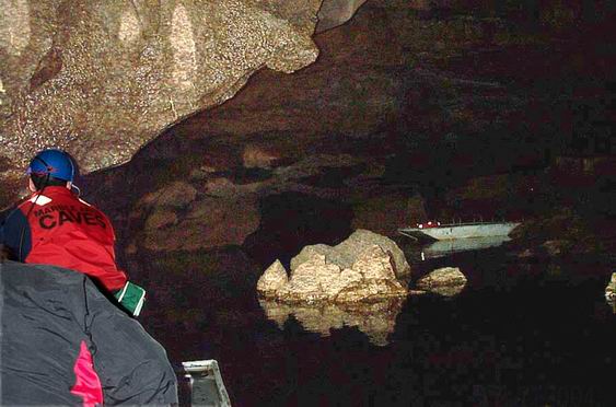 On board a boat in  the cave.