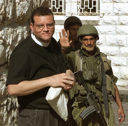 Rev Andrew White with soldier escort