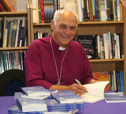 Bishop Ken Clarke signing his book