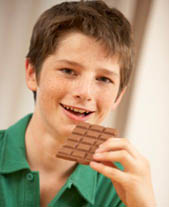 boy eating bar of chocholate